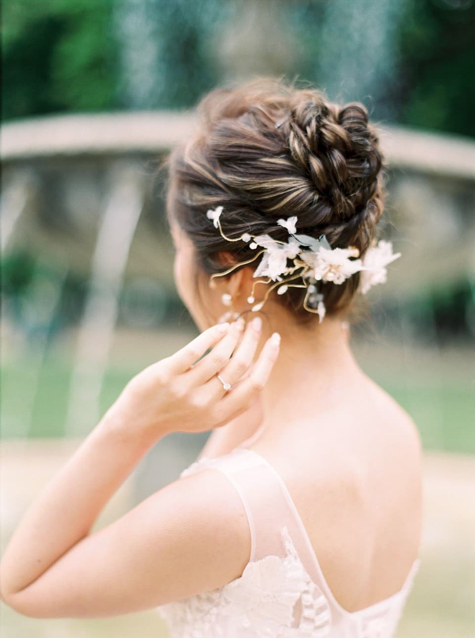 Bride with a soft updo pinned with white flowers